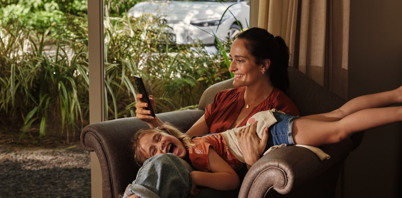 Woman sat on armchair with daughter
