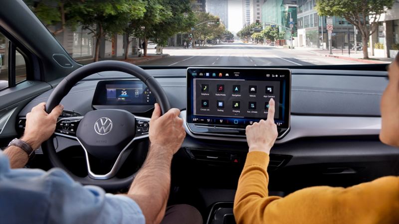 A woman is using the touchscreen in the 2024 VW ID.4