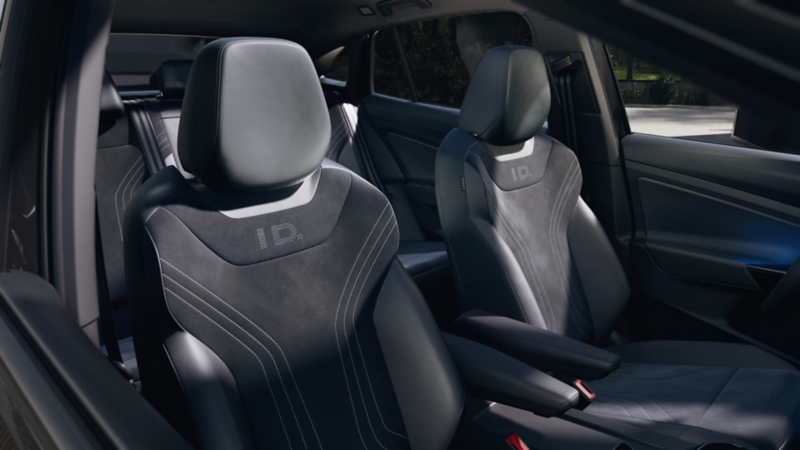 Innenansicht des VW ID.5 Black Edition. Zu sehen sind die Vordersitze mit ID-Logo und roten Details sowie ein Teil der Rückbank. 
