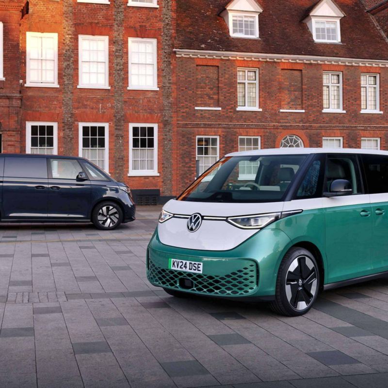 an ID. Buzz and ID. Buzz Cargo parked and charging at a public charger