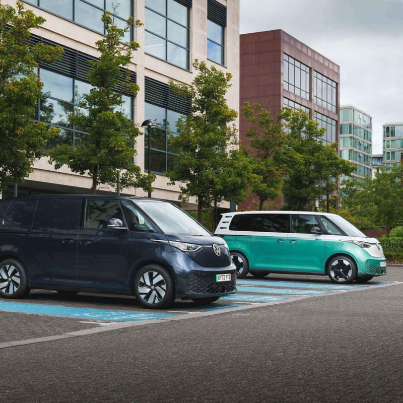 an ID. Buzz and ID. Buzz Cargo parked and charging at a public charger