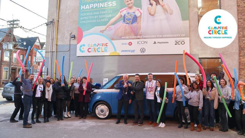 Volkswagen Canada and Campfire Circle celebrating in front of a blue ID.Buzz vehicle