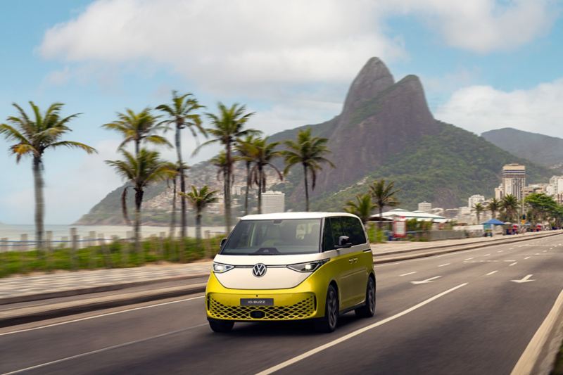 Volkswagen ID.Buzz amarelo dirigindo em uma avenida do Rio de Janeiro