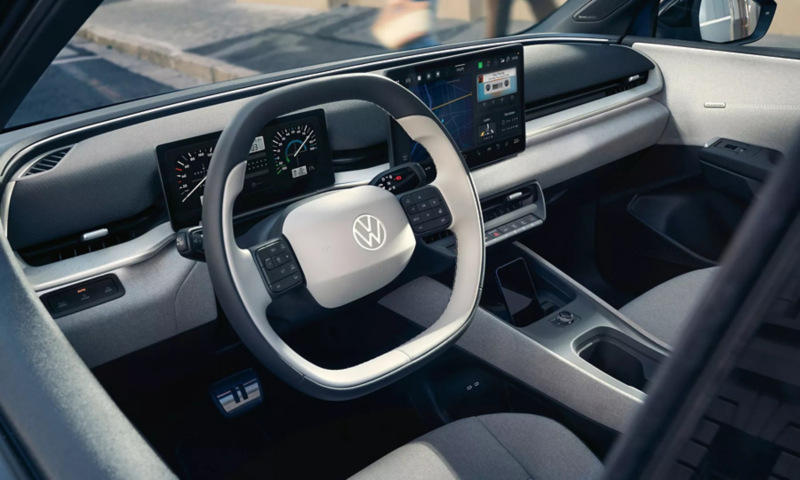 The interior of a VW showing the steering wheel and centre console