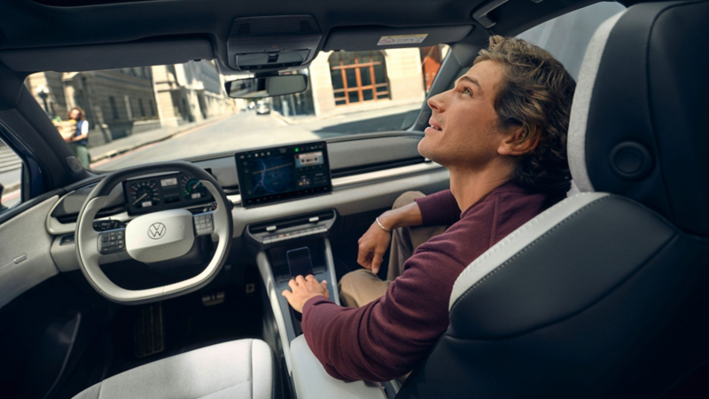 A man sits at the steering wheel of a VW ID. Polo.