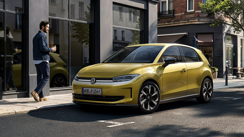 En man går förbi en gul VW Polo som står parkerad vid vägkanten.