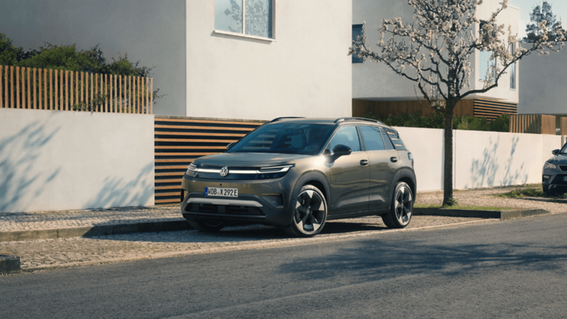 A new Volkswagen ID. Cross parked outside of a house