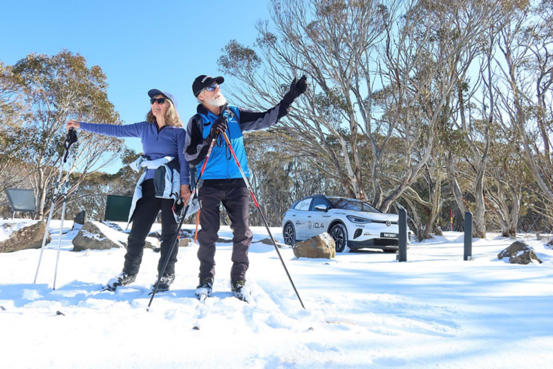 Two skiers with ID.4 parked behind
