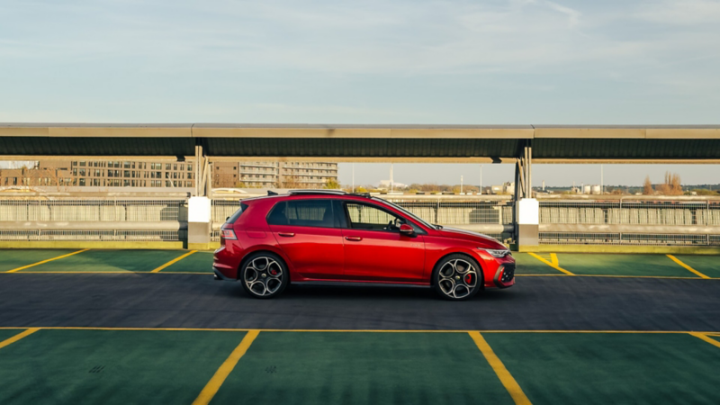 Sideview of a red Golf GTI in a car park
