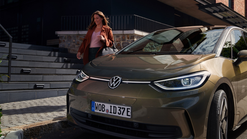 Woman standing next to a Volkswagen ID.