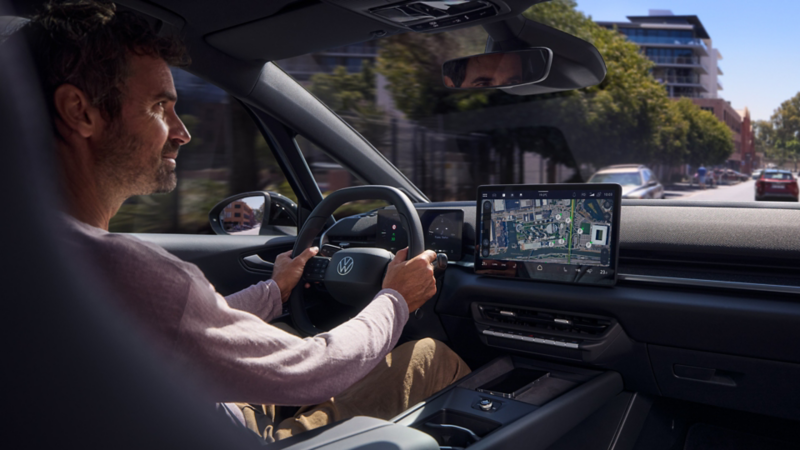 A man drives a VW ID.3 Neo following the online navigation on the centre display.