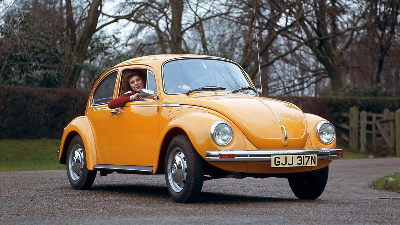 Woman driving Vintage Volkswagen Beetle
