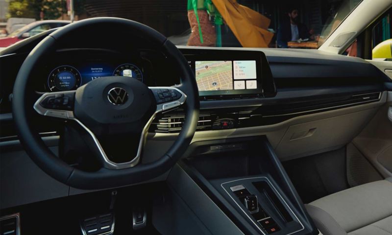 Interior of the VW Golf with a view of the multifunction steering wheel and Composition radio with large touchscreen.