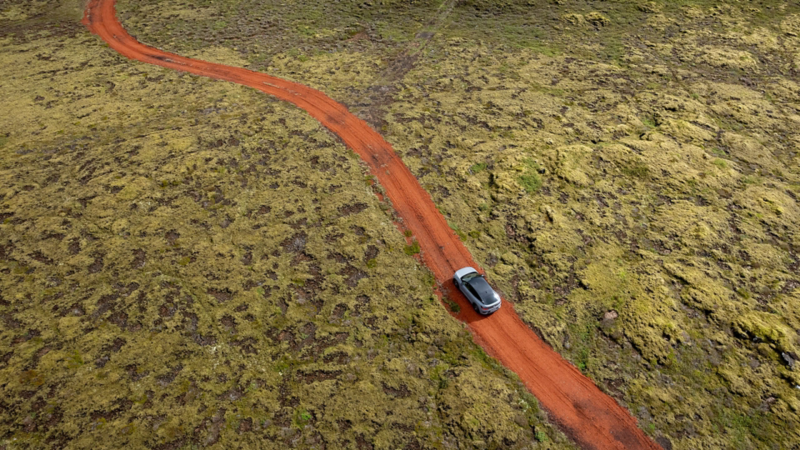 Eine feuerrote Strasse führt durch ein moosbewachsenes Lavafeld – und weit und breit sind keine Anzeichen von Zivilisation zu erkennen.