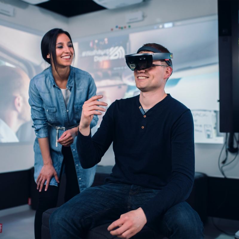 Man mit VR-Brille und eine Frau arbeiten in einem Lab