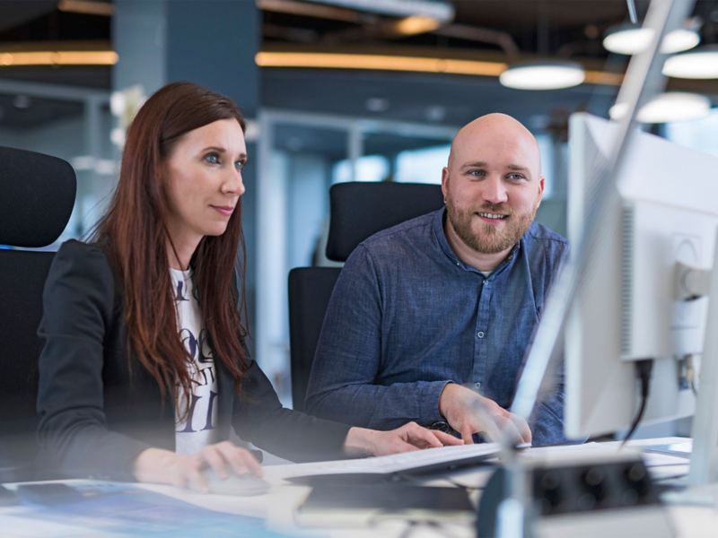 A woman and a man looking at a computer screen together