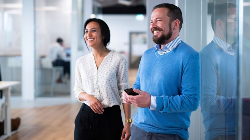 A woman and a man holding a smartphone