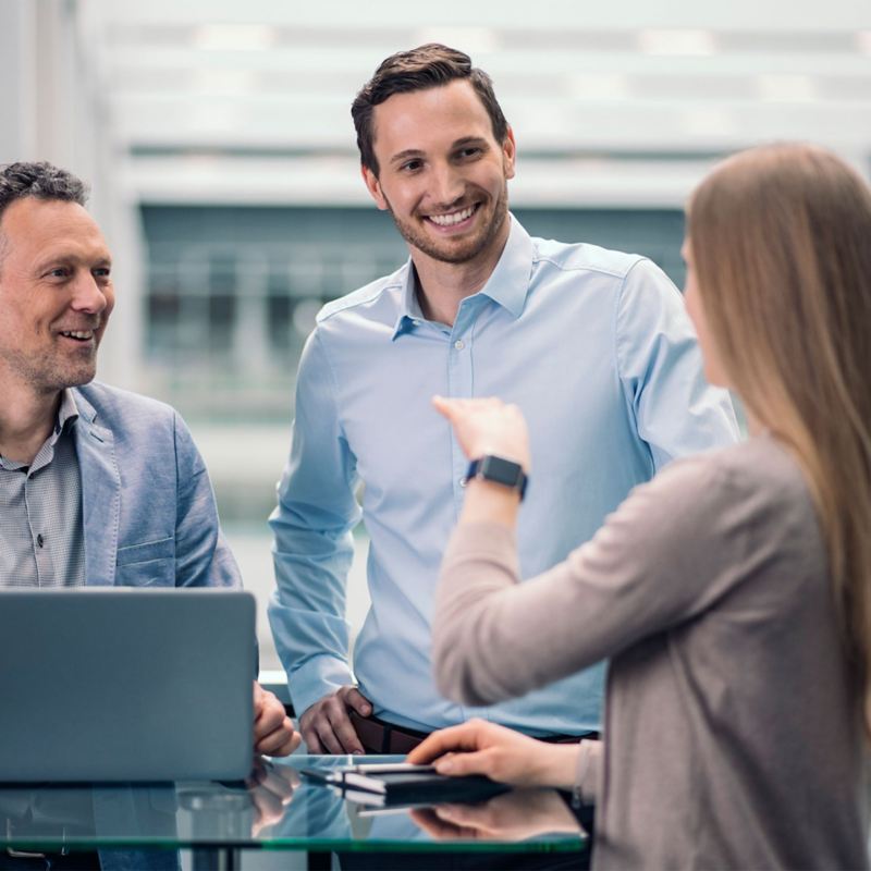 Three colleagues in conversation