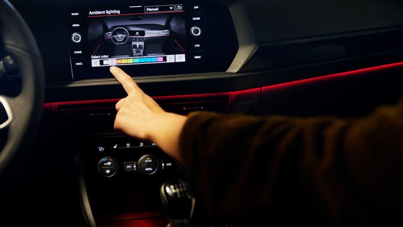 A woman is touching the dashboard in the 2022 Volkswagen Jetta GLI.