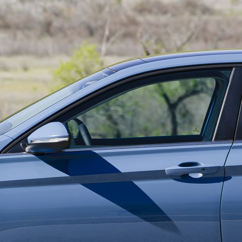 Close-up of the 2025 VW Jetta's driver-side door, highlighting the KESSY keyless access feature with a push-start button.