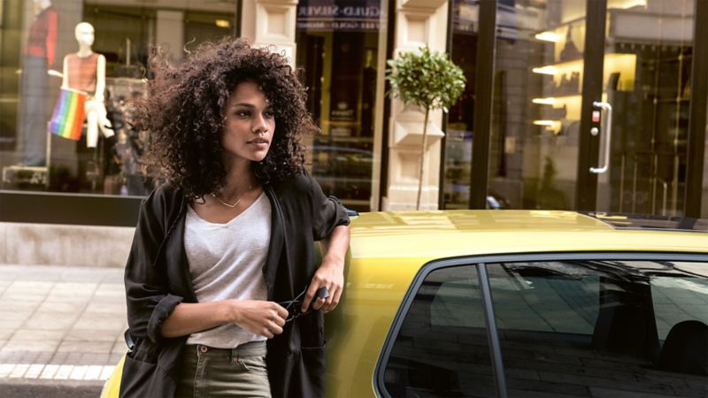 Headshot of a woman next to a Volkswagen