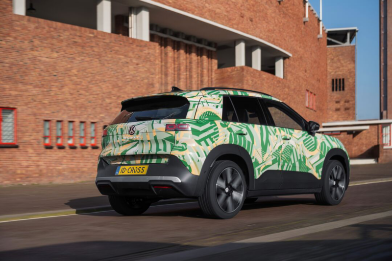 A VW ID. Cross with concept wrap in 3/4-front view before urban architecture.
