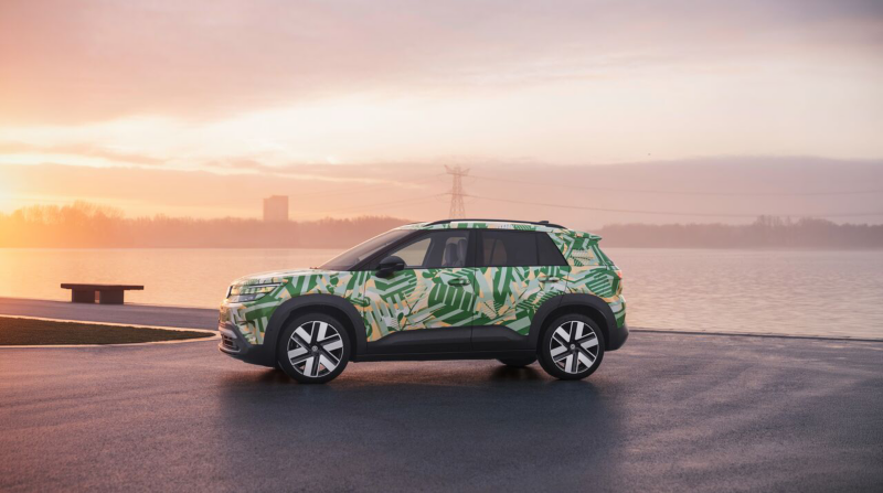 A VW ID. Cross with concept wrap on a modern rooftop parking deck.