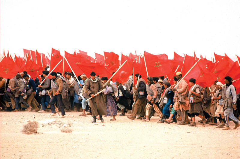 Side view of a moving white VW Golf eHybrid.