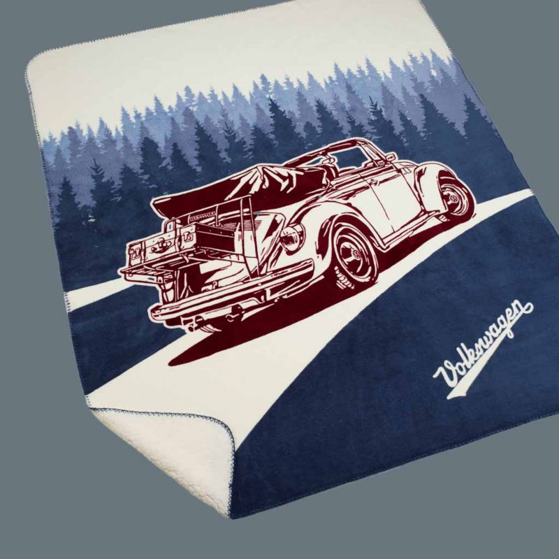 Telo mare originale Volkswagen con stampa grande del Maggiolino in versione cabriolet che percorre una strada circondata da alberi.