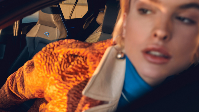 A woman sits in her VW Golf R – sporty interior