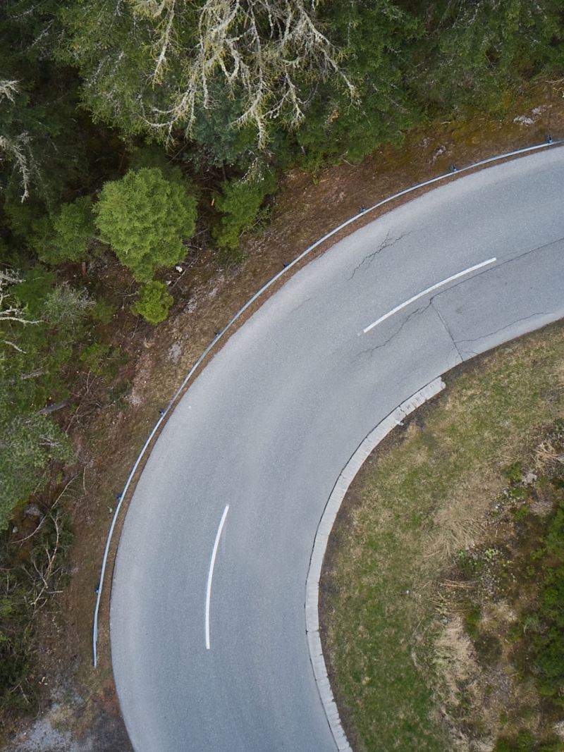 From a bird's eye view, a curve can be seen, with forest to the left and right