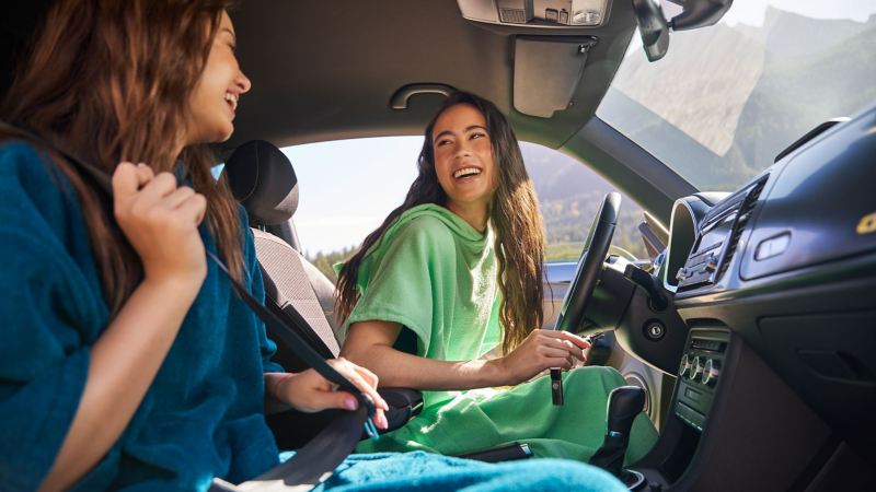 Two women in a VW compact car