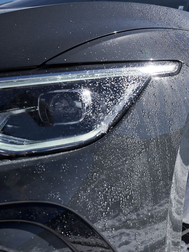 A VW car in the snow – focus on the left headlight