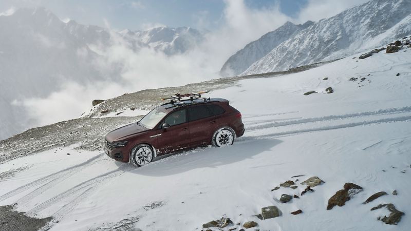A VW car off-road on snowy terrain – complete winter wheels