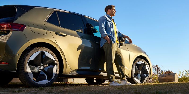 Man leans against a VW ID.3