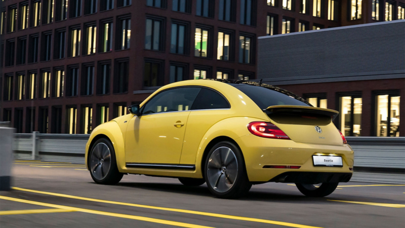 A woman and her used compact class VW Beetle