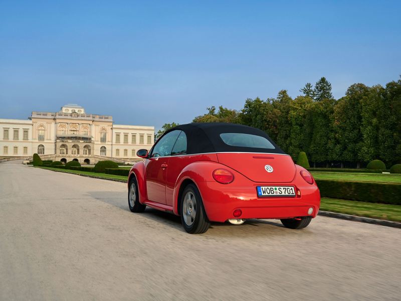 VW New Beetle drives on a road