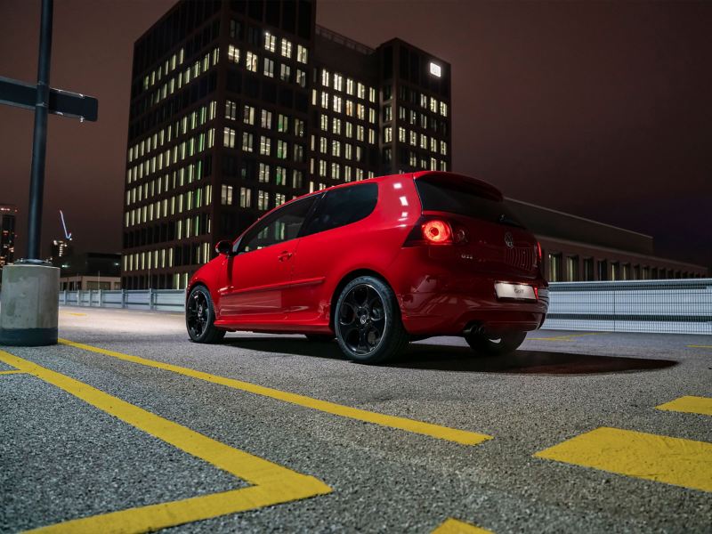 A used compact class car on the road – VW Golf 5 at night