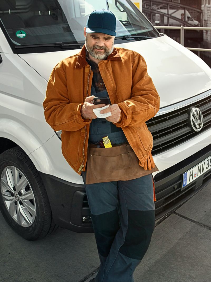 Der Fahrer eines VW Transporters nutzt das digitale Kostenbuch.