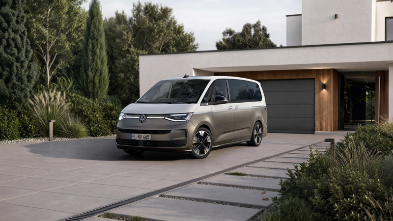 Minibussen VW Multivan står parkerad på en garageuppfart