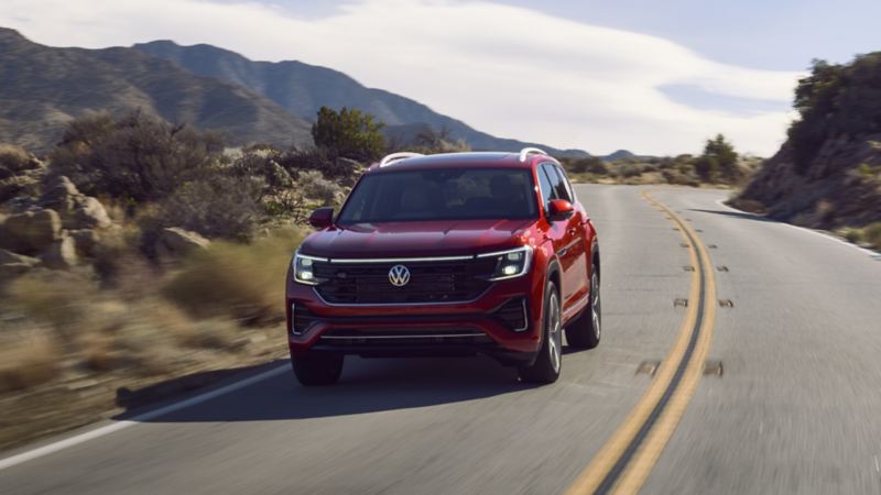 The red 2024 Volkswagen Atlas driving down a mountain road