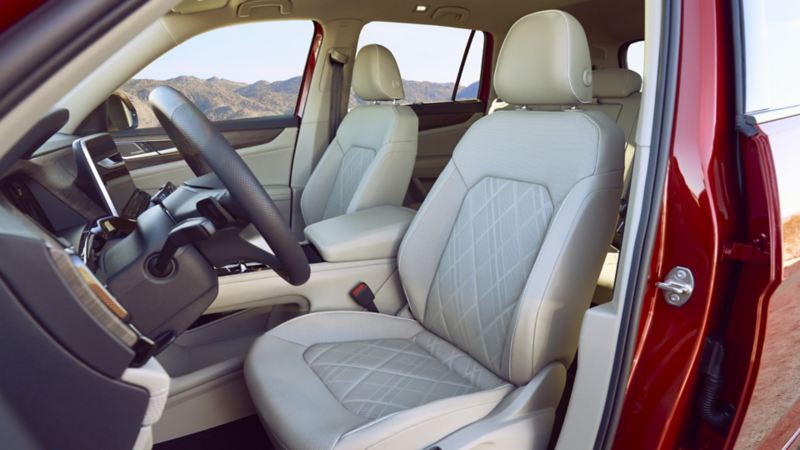 The interior of the 2024 Volkswagen Atlas featuring front seats and steering wheel