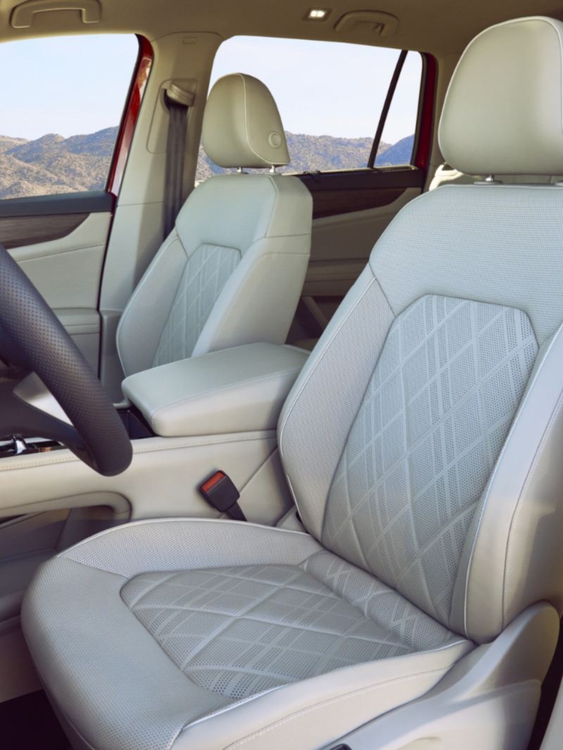The interior of the 2024 Volkswagen Atlas featuring front seats and steering wheel