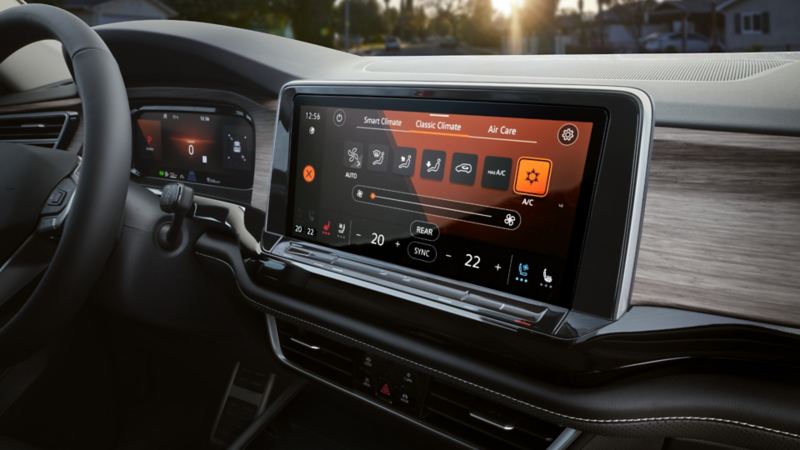 The interior view of the 2024 Volkswagen Atlas featuring steering wheel, dashboard, advanced climate control, and more