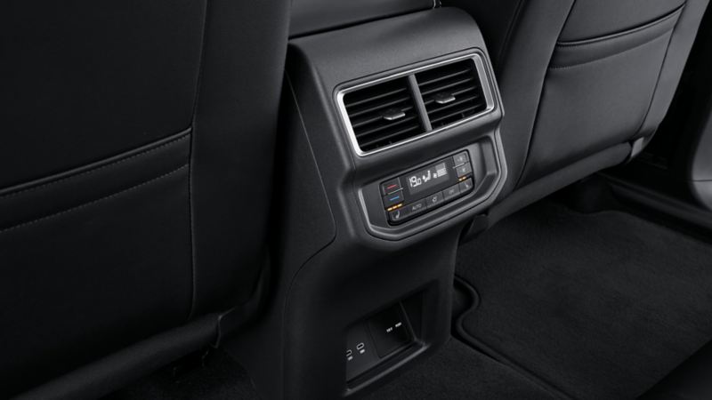 The close-up photo of the infotainment located at the back of the front seats.