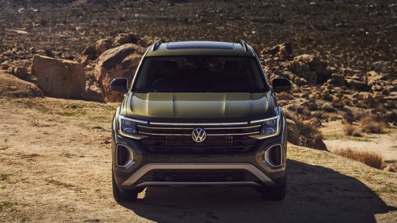 The Avocado Green 2024 Volkswagen Atlas parked on the rocky road