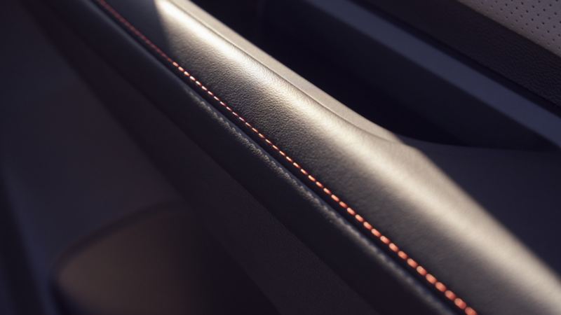 The 2024 Volkswagen Atlas Peak Edition close-up photo of the premium orange stitching