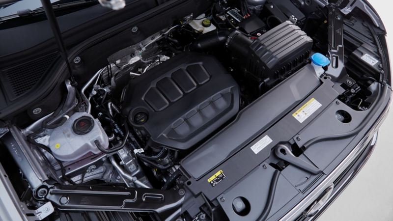 The view under the hood of the 2024 Volkswagen Atlas featuring standard turbocharged 4-cylinder engine
