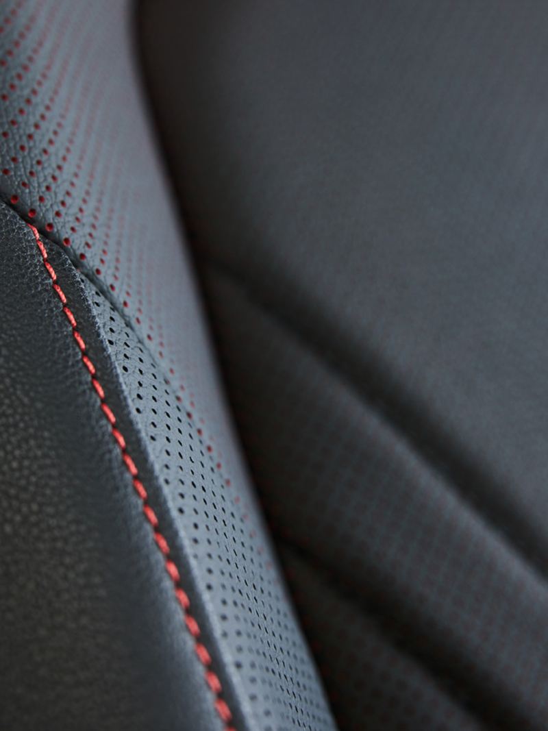 Jetta GLI 2024 black leather car seat with red stitching.