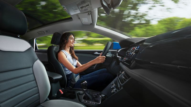 A woman sitting inside of the 2024 Volkswagen Taos 